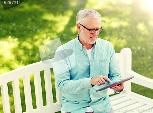 Image of senior man with tablet pc at summer park