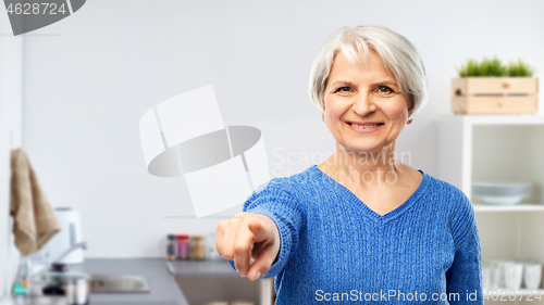 Image of senior woman pointing finger to you at kitchen