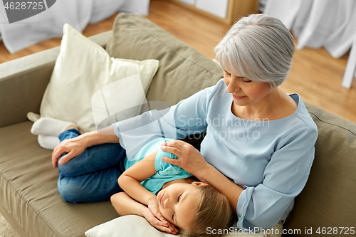 Image of grandmother and granddaughter resting on pillow