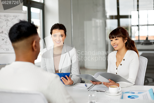 Image of recruiters having job interview with male employee