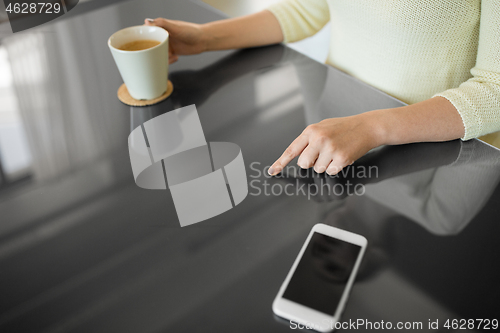 Image of woman with coffee using black interactive panel