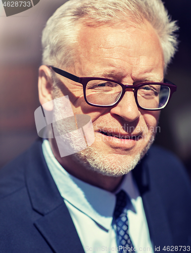 Image of close up of senior businessman in eyeglasses