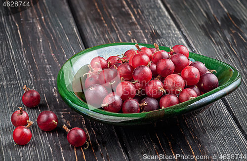 Image of Red gooseberries on a dark table