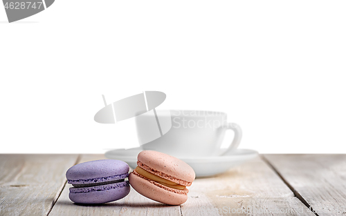 Image of Two macaroons with a cup coffee