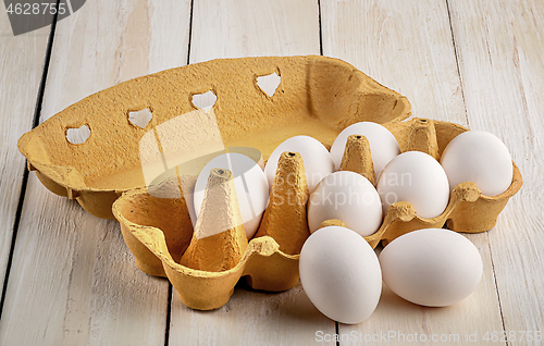 Image of Eggs near the tray on white table
