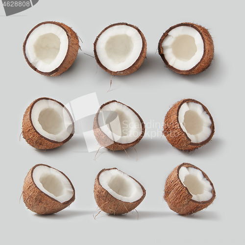 Image of Fresh ripe tropical coconut fruits pattern on a light grey background