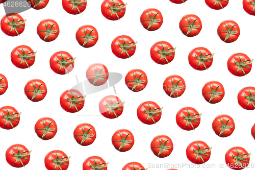 Image of Vegetarian pattern from fresh organic tomatoes against white background.