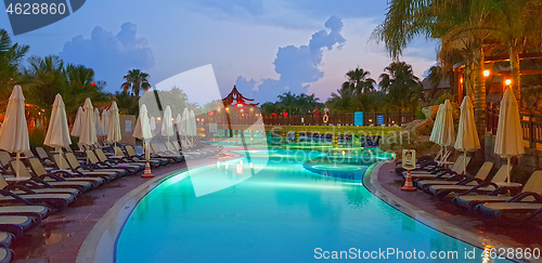 Image of Empty poolside aflter sunset