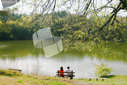 Image of Couple on bench near the lake