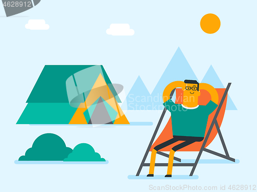 Image of Man sitting in a folding chair in the camping.