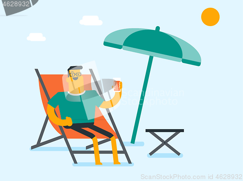 Image of Young caucasian man relaxing on the beach chair.