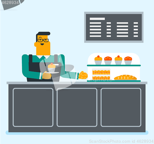 Image of Worker standing behind the counter in the bakery.