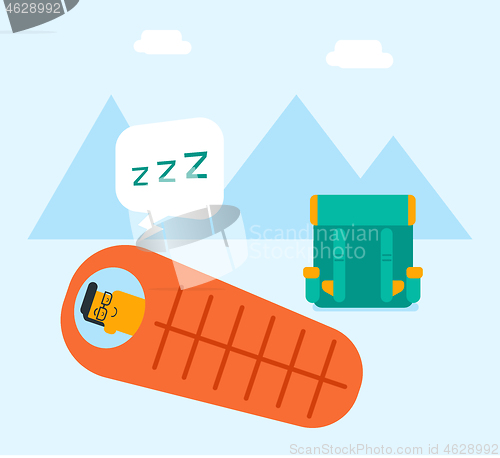 Image of Man sleeping in a sleeping bag in the mountains.