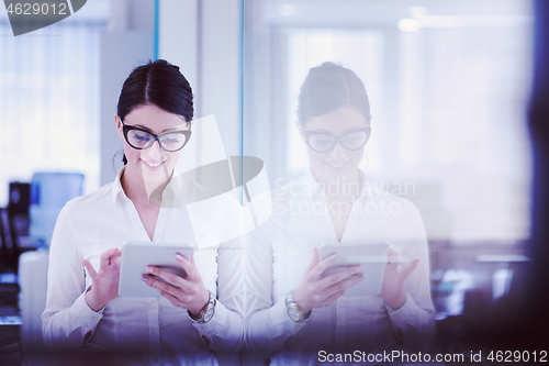 Image of Business Woman Using Digital Tablet in front of startup Office