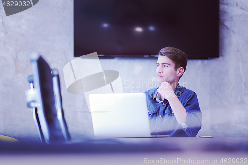 Image of businessman working using a laptop in startup office