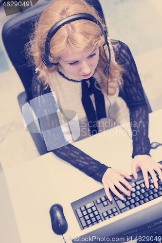 Image of female call centre operator doing her job top view