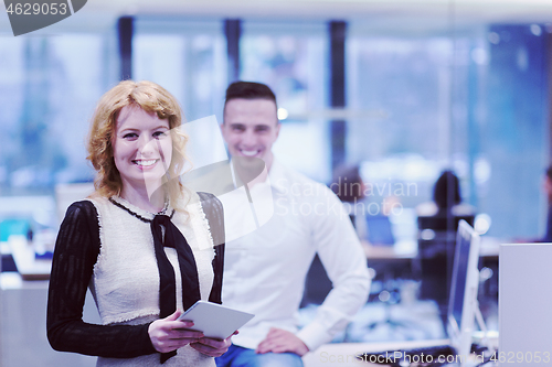 Image of Business People Working With Tablet in startup office