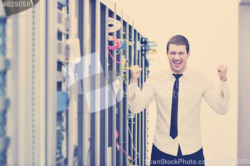 Image of young engeneer in datacenter server room