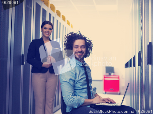 Image of Team of young technicians working together on servers