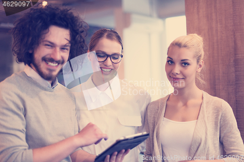 Image of Business People Working With Tablet in startup office