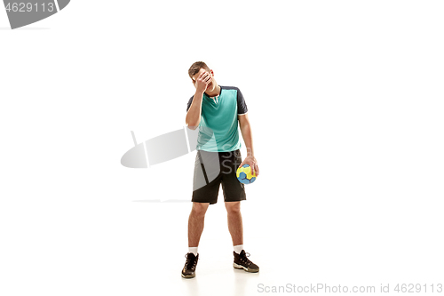 Image of The one caucasian young man as handball player at studio on white background