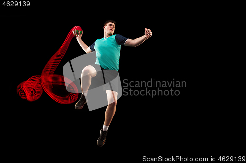 Image of The one caucasian young man as handball player at studio on black background