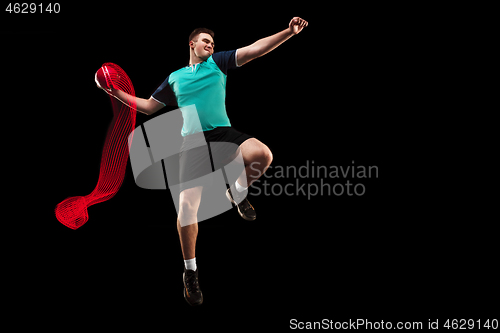 Image of The one caucasian young man as handball player at studio on black background