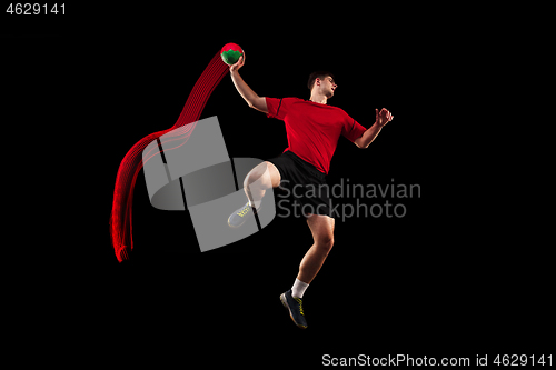 Image of The one caucasian young man as handball player at studio on black background