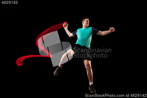 Image of The one caucasian young man as handball player at studio on black background