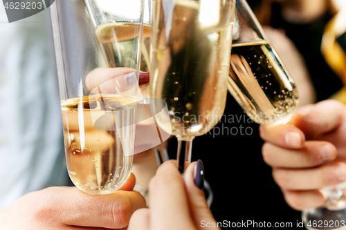 Image of Celebration. Hands holding the glasses of champagne and wine making a toast.