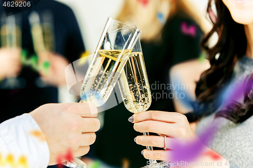 Image of Celebration. Hands holding the glasses of champagne and wine making a toast.