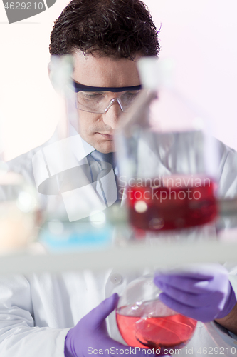 Image of Chemist in chemical laoratory searching for the right solution.