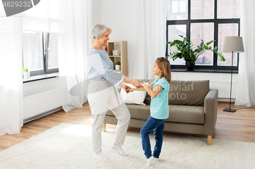 Image of grandmother and granddaughter having fun at home
