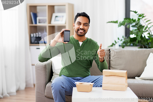 Image of indian man using smartphone for food delivery