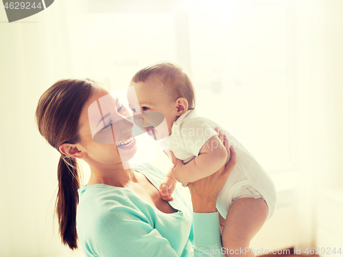 Image of happy young mother with little baby at home