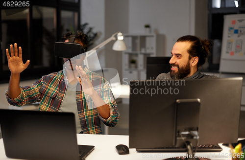 Image of creative man in virtual reality headset at office