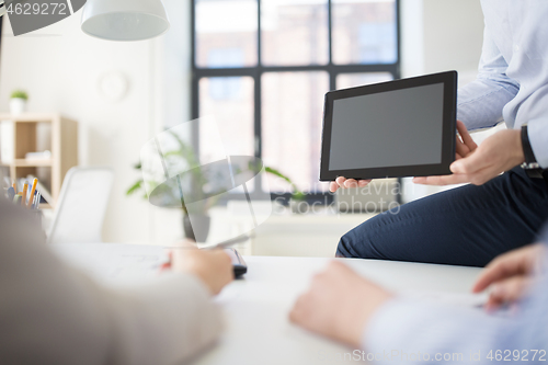 Image of close up of business team with tablet pc at office