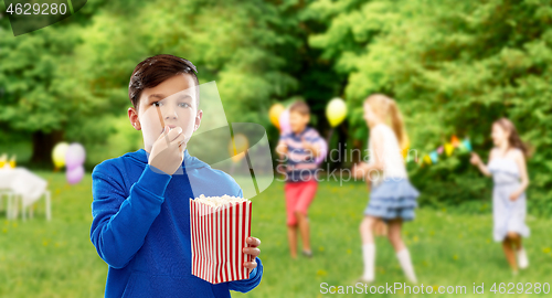 Image of boy eating popcorn at birthday party