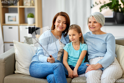 Image of mother, daughter and grandmother taking selfie