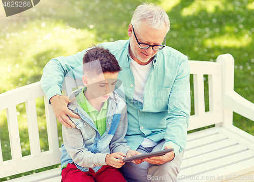 Image of grandfather and boy with tablet pc at summer park