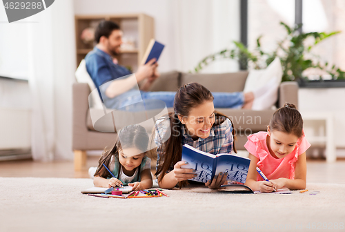 Image of mother with little daughters drawing at home