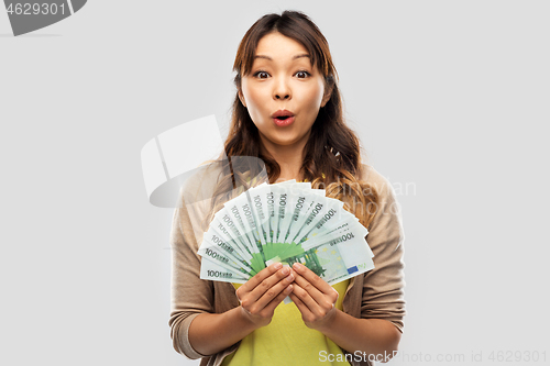 Image of asian woman with hundred euro money banknotes