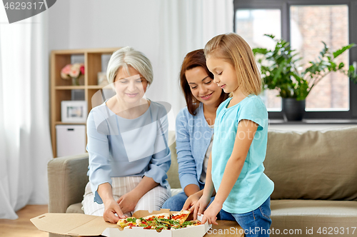 Image of mother, daughter and grandmother eating pizza