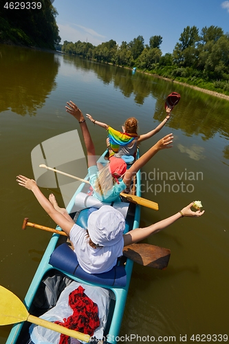 Image of Canoeing on a river, girls in the boat