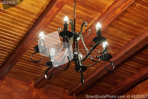 Image of Chandelier in a wooden house