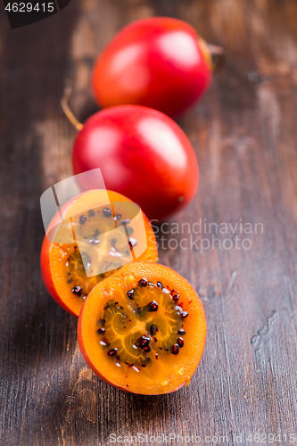 Image of Fresh tamarillo fruit on wooden background