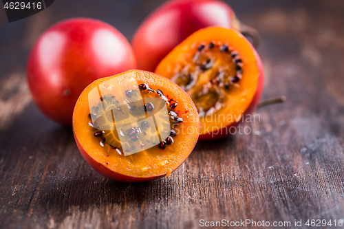 Image of Fresh tamarillo fruit on wooden background