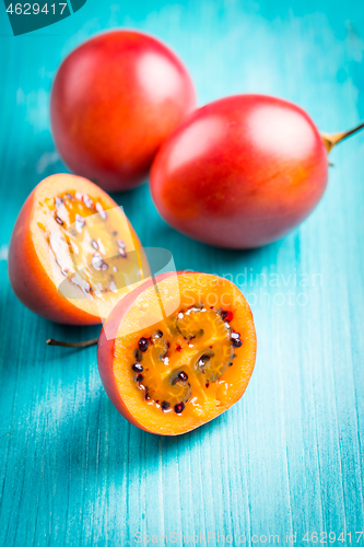 Image of Fresh tamarillo fruit on wooden background