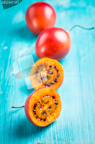 Image of Fresh tamarillo fruit on wooden background