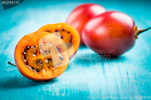 Image of Fresh tamarillo fruit on wooden background